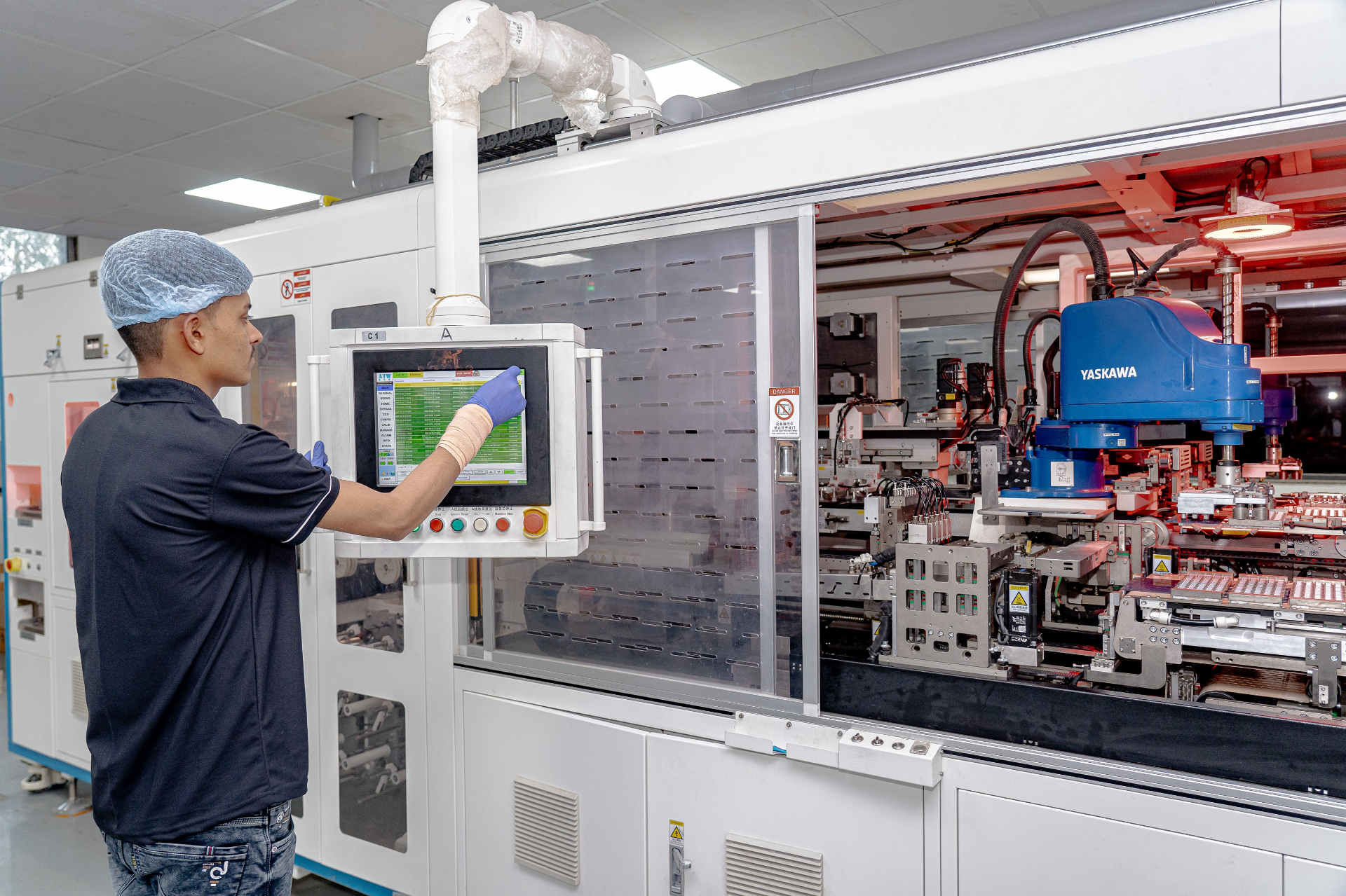 GGBL operator monitoring an automated solar cell production line